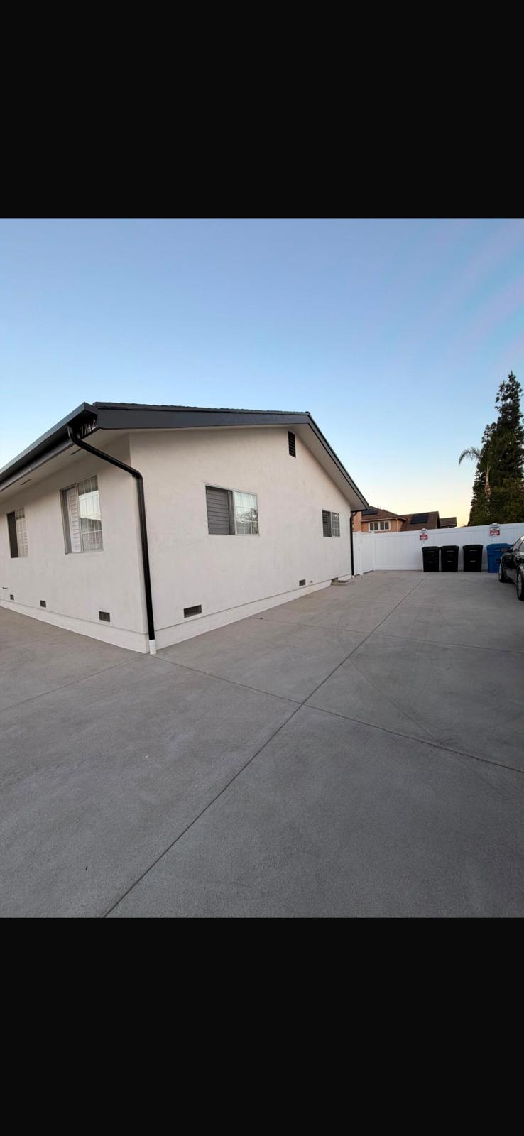 Completed white stucco home side